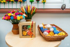 Ozdoby wielkanocne: kwiaty z bibuły we flakonach, pisanki w koszyku wiklinowym, pisanki w prezentowym pudełku z okienkiem