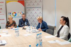 Uczestnicy konferencji siedzący pry stole