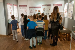 kobieta oprowadza dzieci po muzeum 