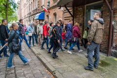 Uczestnicy spotkania wchodzą do jednego z zabytkowych budynków
