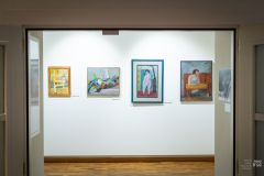 Wejście na wystawę dzieł malarskich, w tle na ścianie obrazy